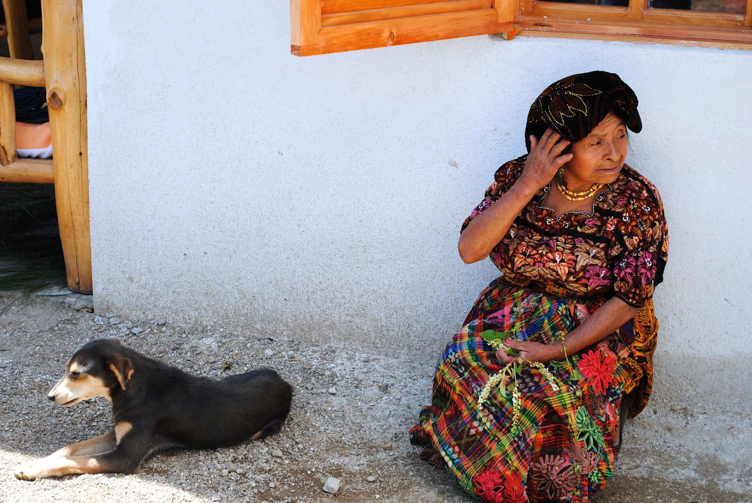 colorfully dressed old lady with dog guatemala