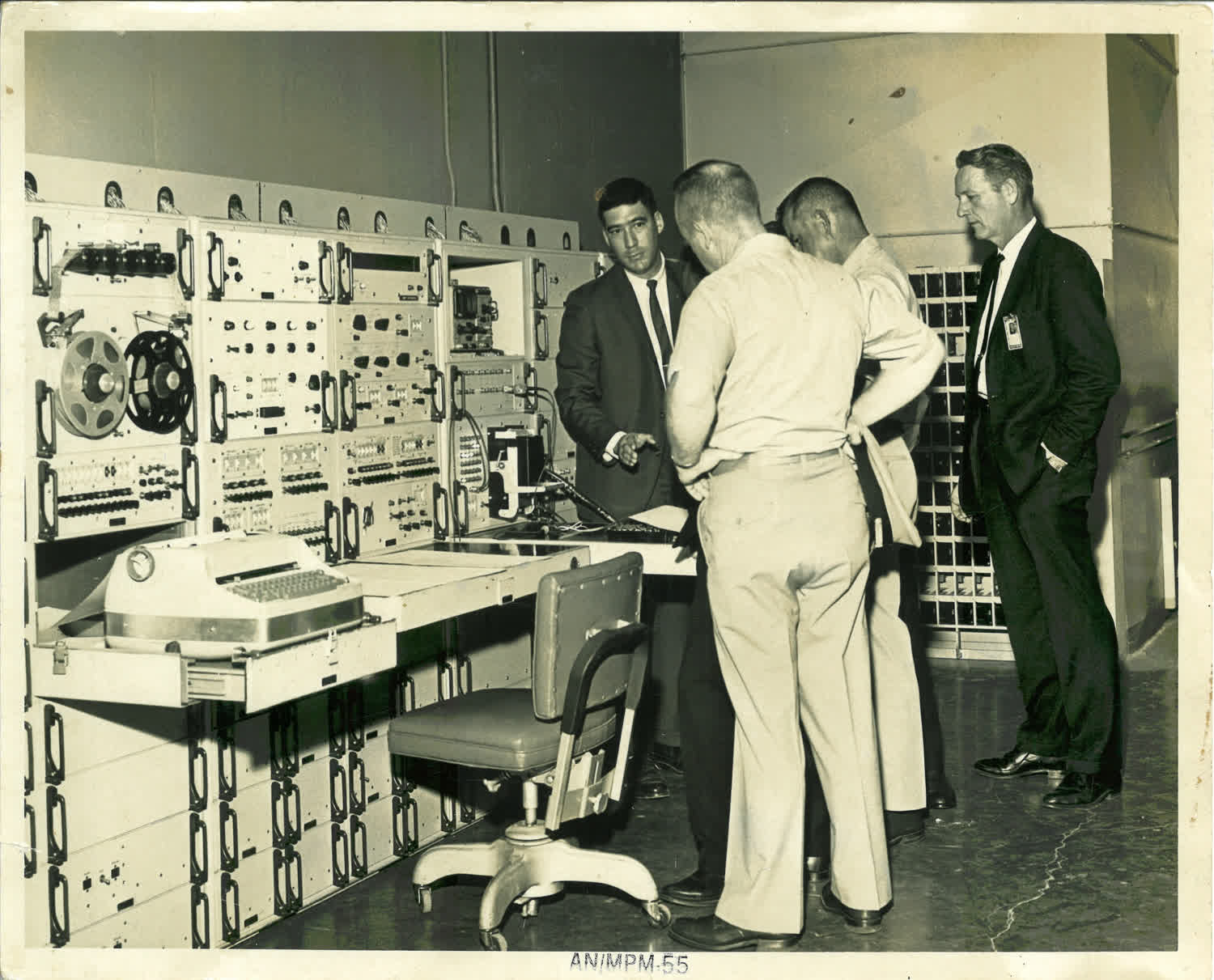 My father demos testing equipment for some high-ranking Army officials.